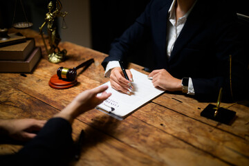 Lawyer assisting client signing legal contract document
