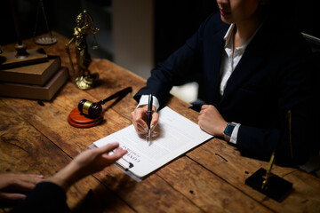 Lawyer signing legal contract document in law firm office
