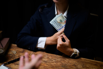 Woman making illicit deal involving cash and bribe payment