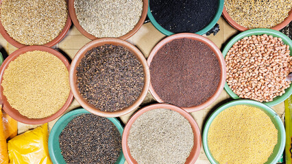 Colorful Indian Spices and Grains in Bowls - Top View Food Background.