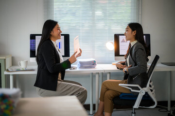 Fototapeta premium Business women discussing report data in modern office
