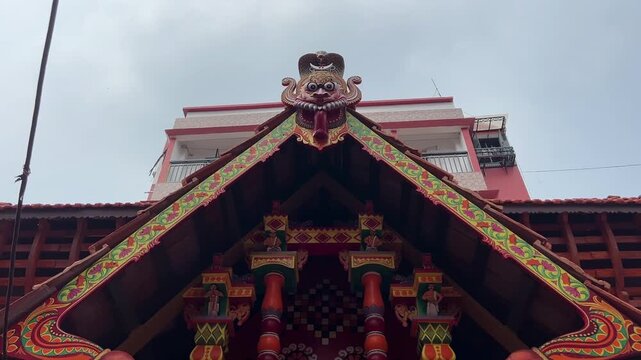 South Indian style temple with Kolam art in wall and red brick structure. 