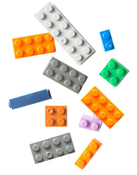 colorful assortment of plastic building blocks scattered on a transparent background