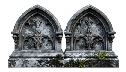 Two gothic-style stone tomb markers, weathered and ornate