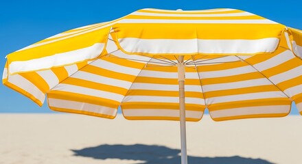 Yellow and White Striped Beach Umbrella on Sandy Shore.