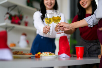 Friends celebrating holiday party toasting with wine glasses