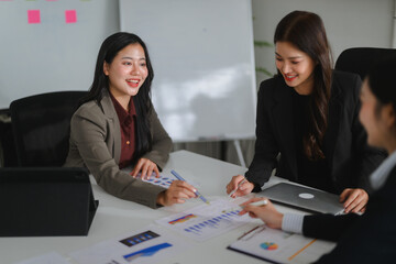 Businesswomen discussing charts and working together