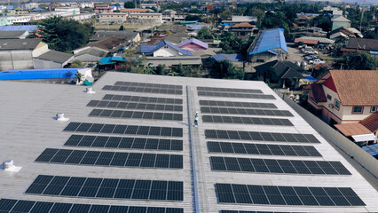 Top view of Engineer man walking to checking solar cell on roof top at industrial factory
