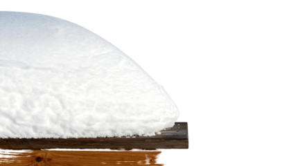 A curved, snow-like mound sits on a wooden surface