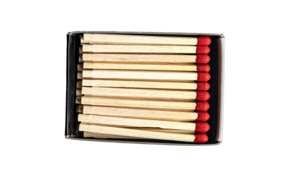 Matchsticks in a box.  Close-up view of several light beige matchsticks neatly arranged in a clear plastic box.  Red heads are visible