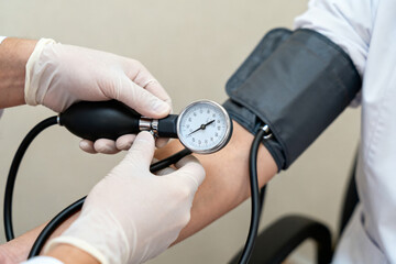 Medical professional measuring blood pressure using a sphygmomanometer on a patient's arm