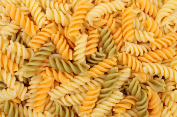 Cooked tricolore fusilli three colour pasta detail texture background
