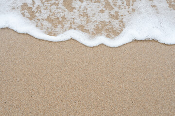 soft ocean wave gently washing over sandy beach shore, creating a peaceful and relaxing natural background, perfect for travel, wellness, meditation, or minimalist design content.