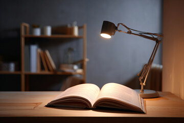 Open book under desk lamp with cozy evening study atmosphere