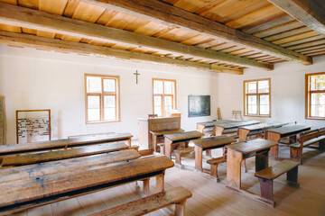Antique classroom with wooden desks and benches