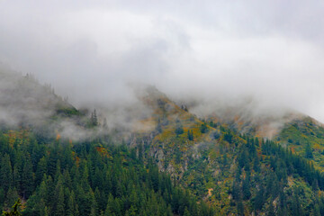 Landscape with fog on top of mountains after rain
