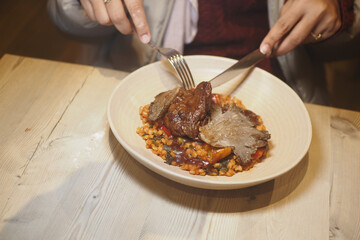 Enjoying a hearty meal of meat and vegetables