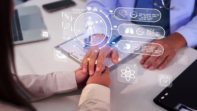 Doctor holding patient hand medical examination with medical information on digital screen at clinic healthcare concept