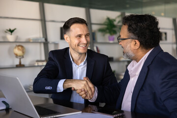Two businessmen shaking hands, starting new business collaboration