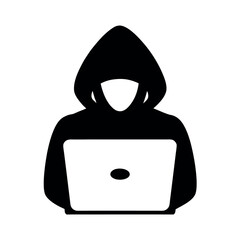 Anonymous hacker in a black hoodie using a laptop computer for cybercrime and digital security threats