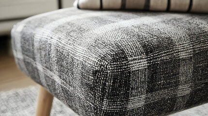 Close-up of a patterned upholstered chair seat with a pillow resting on it.
