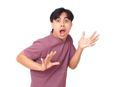 Funny young Asian man with open mouth and raised hands showing shocked reaction while looking at camera on plain background, perfect for emotion and lifestyle concept.