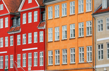 Fototapeta premium Typical Scandinavian houses with vibrant red and orange colors and windows