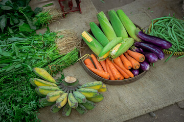A vibrant assortment of fresh vegetables including zucchini, carrots, and eggplants in a market setting.