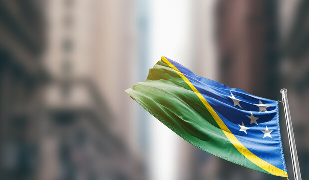 Solomon Islands national flag waving on street. A beautiful with mast with blur buildings. Solomon Islands national flag for independence day. - Powered by Adobe