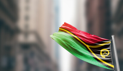 Vanuatu national flag waving on street. A beautiful with mast with blur buildings. Vanuatu national...
