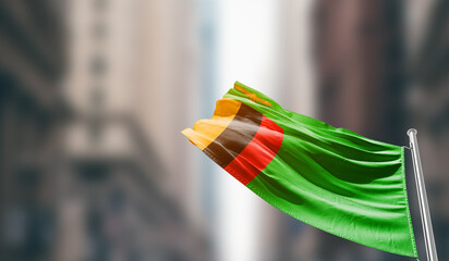 Zambia national flag waving on street. A beautiful with mast with blur buildings. Zambia national...