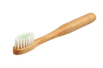 A wooden toothbrush with a green handle. The toothbrush is white and has a green handle