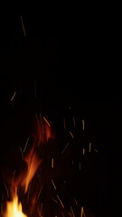 fire flames of campfire with sparks over black background, for overlay
