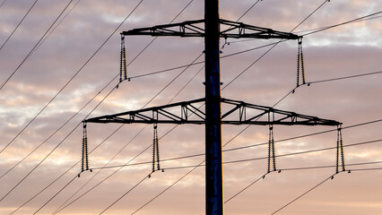 High-voltage power lines at dusk or dawn