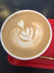 [Spain] A cup of latte  placed on a red tray (Barcelona)