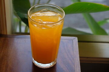 refreshment drink. orange ice on a wooden table. es jeruk.