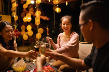 Party and celebration concept, Holidays summer, Group of friends clinking glasses wine on outdoor at night party.