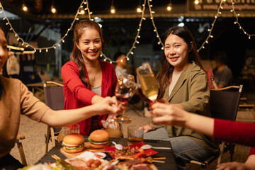 Party and celebration concept, Holidays summer, Group of friends clinking glasses wine on outdoor at night party.