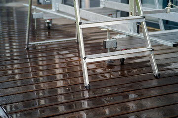 ladder placed on the wet hardwood © vectorass