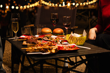 Happy Friends Celebrating Together at Night, Young Asian Group of Friends Having Fun and Toasting Drinks Outdoors, Enjoying a Celebration Concept.