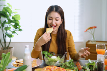 Happy young woman enjoying delicious homemade pizza at home.