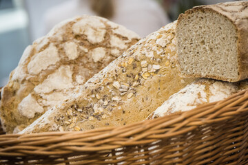 Freshly baked traditional loaves of wheat or rye bread with grains in bakery