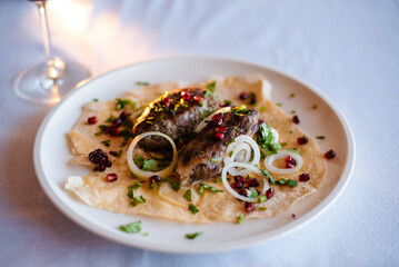 Gourmet Grilled Meat with Pomegranate and Onions