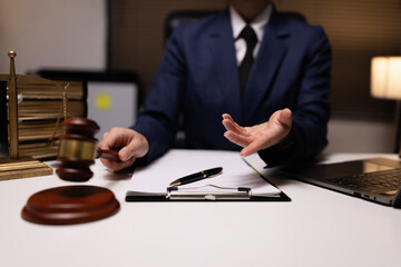Lawyer businesswoman working diligently with signature document in a modern office, Signing contract, Justice and lawyer concept.