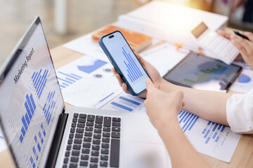 Team planning strategy using graphs and charts in the modern office, Close-up of hands working together on a business analysis meeting, Business Concepts.
