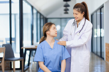 Professional encouragement, Doctor reassuring and supporting her colleague or junior staff member,...