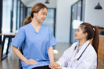 Professional encouragement, Doctor reassuring and supporting her colleague or junior staff member,...