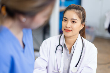 Professional encouragement, Doctor reassuring and supporting her colleague or junior staff member,...