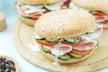 Bun sandwiches with salami and vegetables	