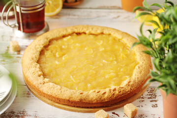 A tart with lemon marmalade served on the table